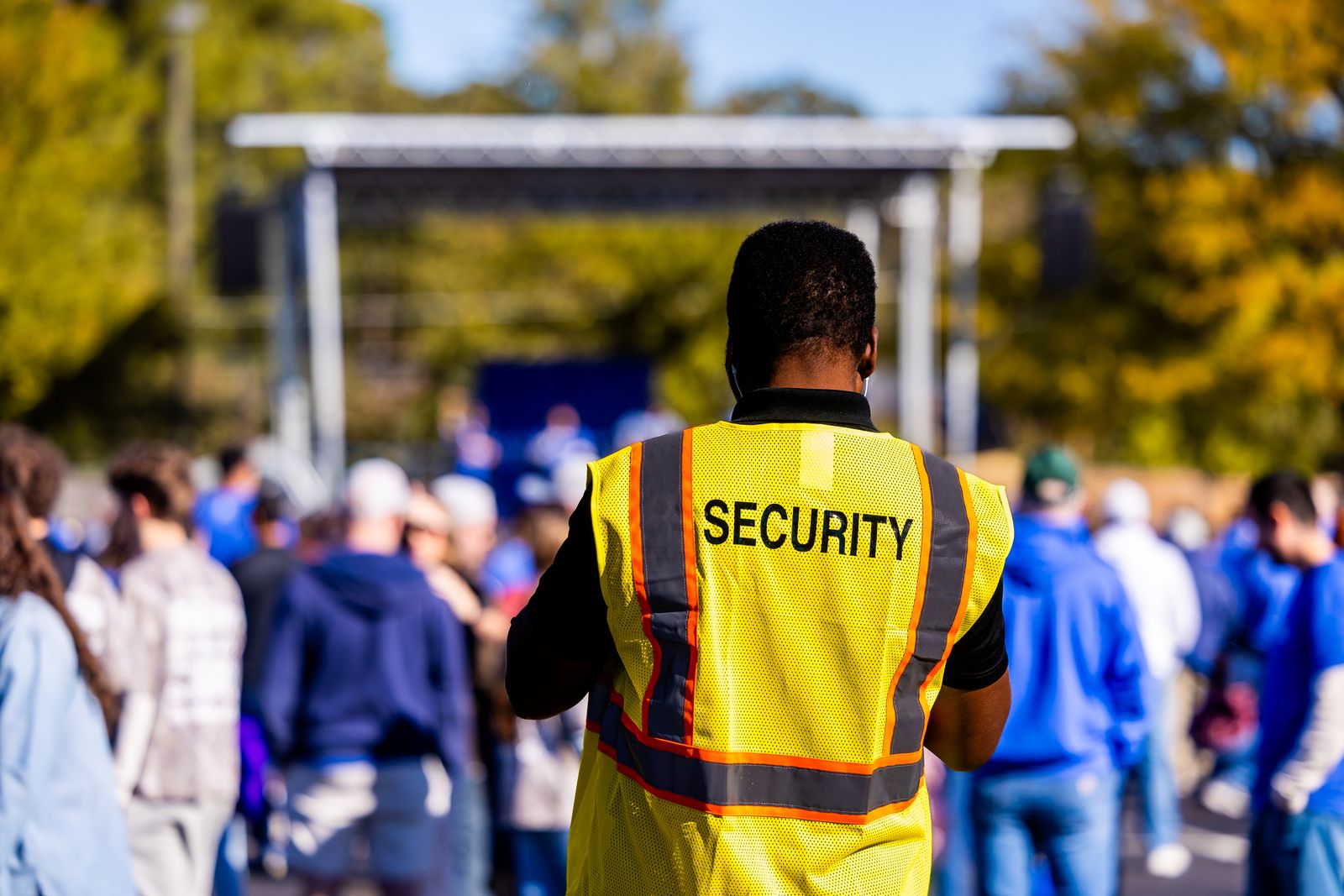 Security officer monitoring a large outdoor event crowd