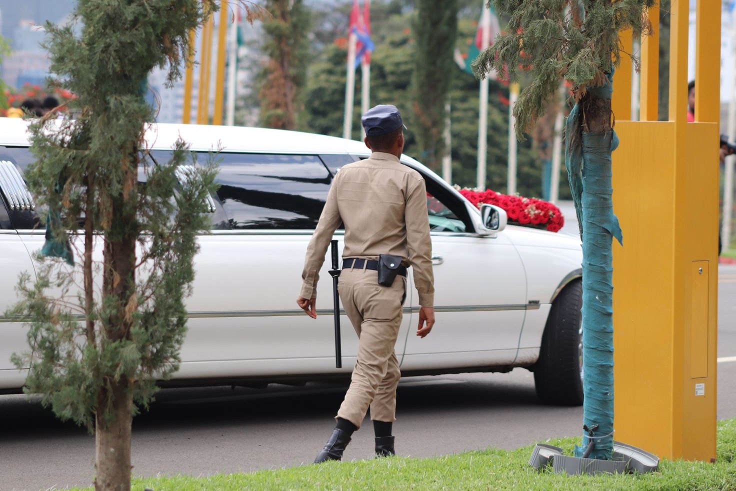 Uniformed security officer beside a patrol vehicle