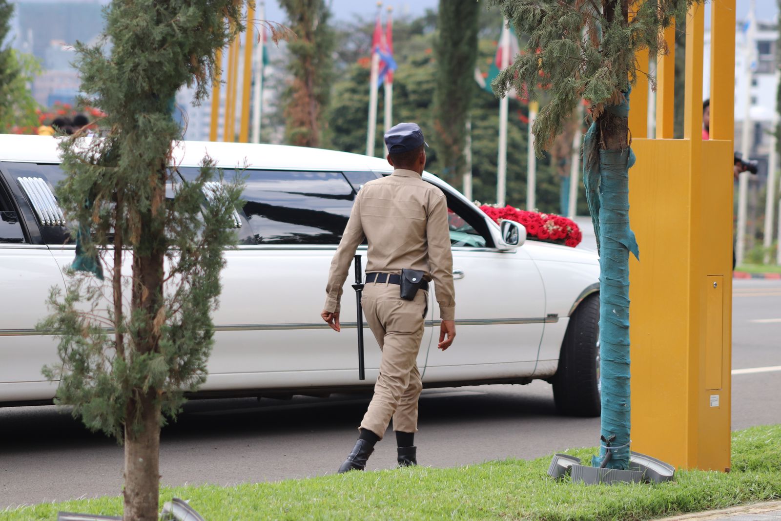 Uniformed security officer beside a patrol vehicle